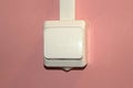White plastic electrical switch on a pink wall Royalty Free Stock Photo