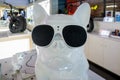 White plastic figurine of a bulldog with sunglasses