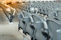 White plastic folding empty red seats in concert or football stadium. Royalty Free Stock Photo