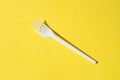 White plastic fork on a yellow background Royalty Free Stock Photo