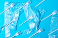 White plastic forks and bags on blue background. Royalty Free Stock Photo