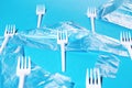 White plastic forks and bags on blue background Royalty Free Stock Photo