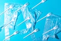 White plastic forks and bags on blue background Royalty Free Stock Photo