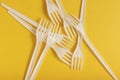 White plastic forks on yellow background. Royalty Free Stock Photo