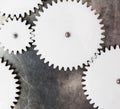 White plastic gears on metal surface Royalty Free Stock Photo
