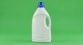 White Plastic Laundry Detergent Bottle with Blue Cap on Green Background Royalty Free Stock Photo