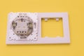 White plastic modern electrical switch and clip frame with white cover on a yellow background Royalty Free Stock Photo