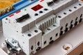 White plastic mounting box with installed automatic circuit breakers and voltage limiter closeup Royalty Free Stock Photo