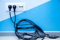 Multiple outlet with a pile of black cable. Royalty Free Stock Photo