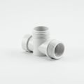 White plastic pipe fitting with a T-shape design placed on a white background. The Royalty Free Stock Photo