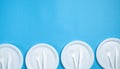 White plastic plates, forks and knifes on blue background Royalty Free Stock Photo