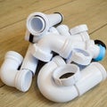 White plastic plumbing, plumbing pipes, smooth and curved, fittings, flanges, rubber gaskets Royalty Free Stock Photo