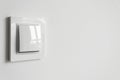 A white plastic power switch in an apartment on a white wall Royalty Free Stock Photo