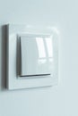 A white plastic power switch in an apartment on a white wall Royalty Free Stock Photo