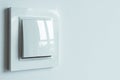 A white plastic power switch in an apartment on a white wall Royalty Free Stock Photo