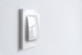 A white plastic power switch in an apartment on a white wall Royalty Free Stock Photo