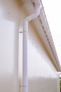 White plastic rain guttering system. Guttering drainage pipe exterior. Royalty Free Stock Photo