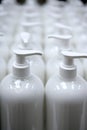 White plastic soap bottles in rows assembly line Royalty Free Stock Photo