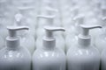 White plastic soap bottles in rows assembly line Royalty Free Stock Photo