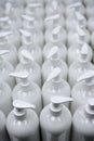 White plastic soap bottles in rows assembly line Royalty Free Stock Photo