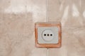 White plastic socket on the wall on the tiles in the kitchen Royalty Free Stock Photo