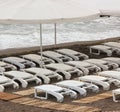 White plastic sun beds on the beach