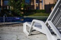 White plastic sun beds by the pool.