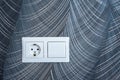 White plastic switched double socket. Light switch and power socket control panel on abstract wallpaper, close-up. Electrical Royalty Free Stock Photo