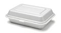 A white plastic takeout container with a lid sitting on a flat surface Royalty Free Stock Photo