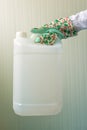 White plastic tank canister in female hand Royalty Free Stock Photo