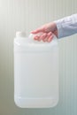 White plastic tank canister in female hand Royalty Free Stock Photo