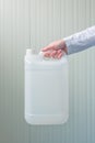 White plastic tank canister in female hand Royalty Free Stock Photo