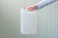 White plastic tank canister in female hand Royalty Free Stock Photo