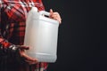 White plastic tank canister in female hand Royalty Free Stock Photo