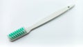 White Plastic Toothbrush Isolated On White Background. Tilted View From Above