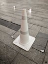 White plastic Traffic cone on a stone block floor