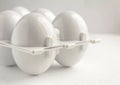 White plastic tray for refillable eggs, close up. Environmental reusable concept, Happy Easter concept on white