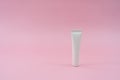 White plastic tube on pink background. ÃÂ¡osmetic bottles for beauty or medicine products Royalty Free Stock Photo