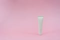 White plastic tube on pink background. ÃÂ¡osmetic bottles for beauty or medicine products Royalty Free Stock Photo