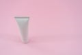 White plastic tube on pink background. ÃÂ¡osmetic bottles for beauty or medicine products Royalty Free Stock Photo