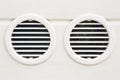 White plastic ventilation grille for internal air conditioner against a plaster wall - Double grille