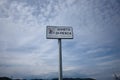 White plate against cloudy sky that says Divieto di Pesca means Fishing prohibited in Italia