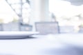 White plate on blurred bakground. Wooden table in restraunt.