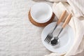 White plate and bowl with spoon and fork with linen napkin on tablecloth background Royalty Free Stock Photo