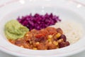 White plate of chili sin carne with red cabbage, guacamole and r Royalty Free Stock Photo