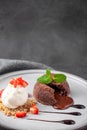 White plate with chocolate fondant cake with ice cream