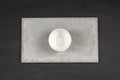 White plate on concrete plate on dark background