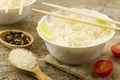 White plate of cooked long-grain rice on wooden background. Healthy eating, diet Royalty Free Stock Photo