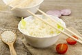 White plate of cooked long-grain rice on wooden background. Healthy eating, diet Royalty Free Stock Photo