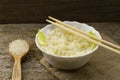 White plate of cooked long-grain rice on wooden background. Healthy eating, diet Royalty Free Stock Photo